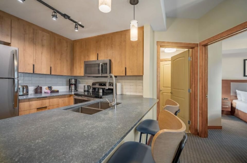 Open-concept kitchen with sleek countertops and modern touches, ideal for preparing and sharing meals.