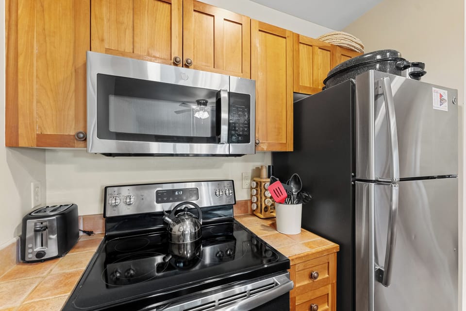 You'll love preparing meals in your fully equipped kitchen with stainless steel appliances and warm wood cabinetry.