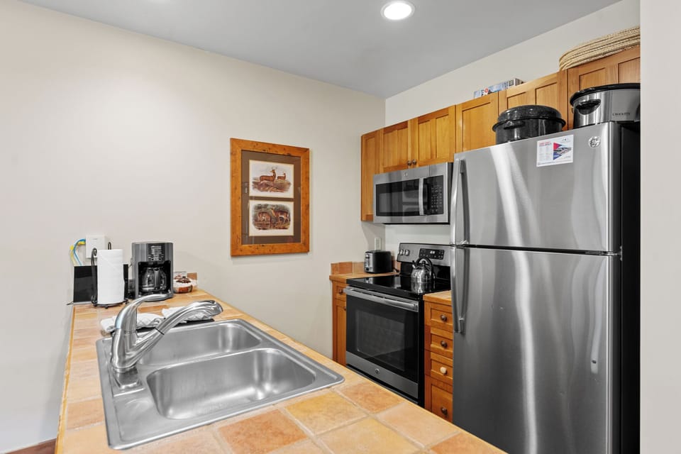 Your fully equipped kitchen features stainless steel appliances, warm wood cabinets, and everything you need to create memorable meals during your stay.