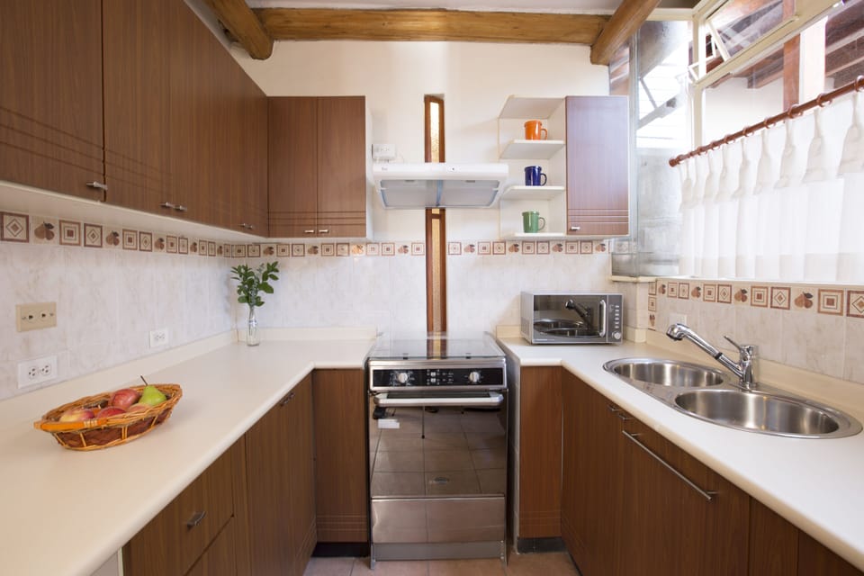 Fully equipped kitchen with electric stove & oven. Window to court yard. 
