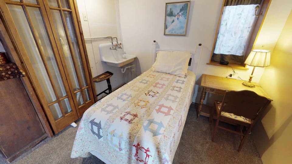 single bed in common space downstairs