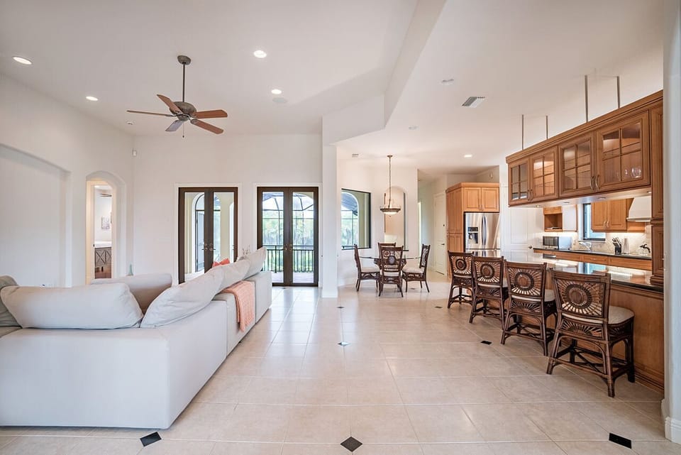 It does not get any better in this beautifully designed home.  A large sectional in the living area with a breakfast table and barstools.