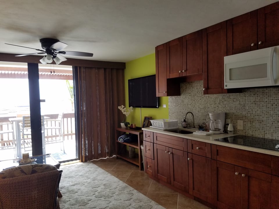 Kitchen and living room with large screen flat screen TV