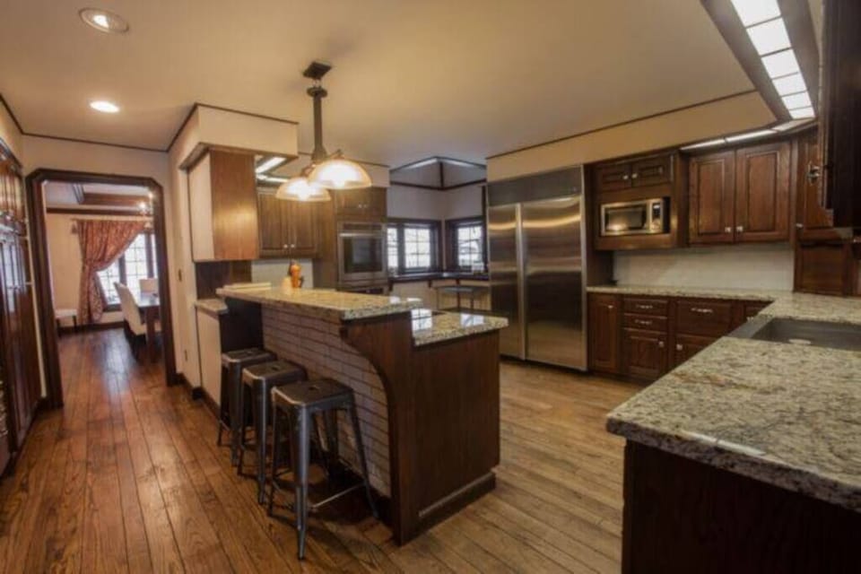 A spacious kitchen with elegant wood finishes, granite countertops, and modern appliances – a chef's paradise in your Alaskan retreat.