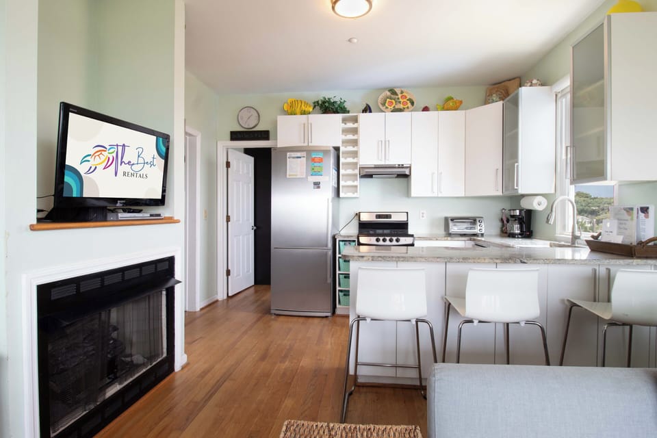 Step into your bright, open-concept living space where hardwood floors flow from kitchen to lounge. Everything you need to feel at home—from the full kitchen to the cozy fireplace—awaits your arrival.