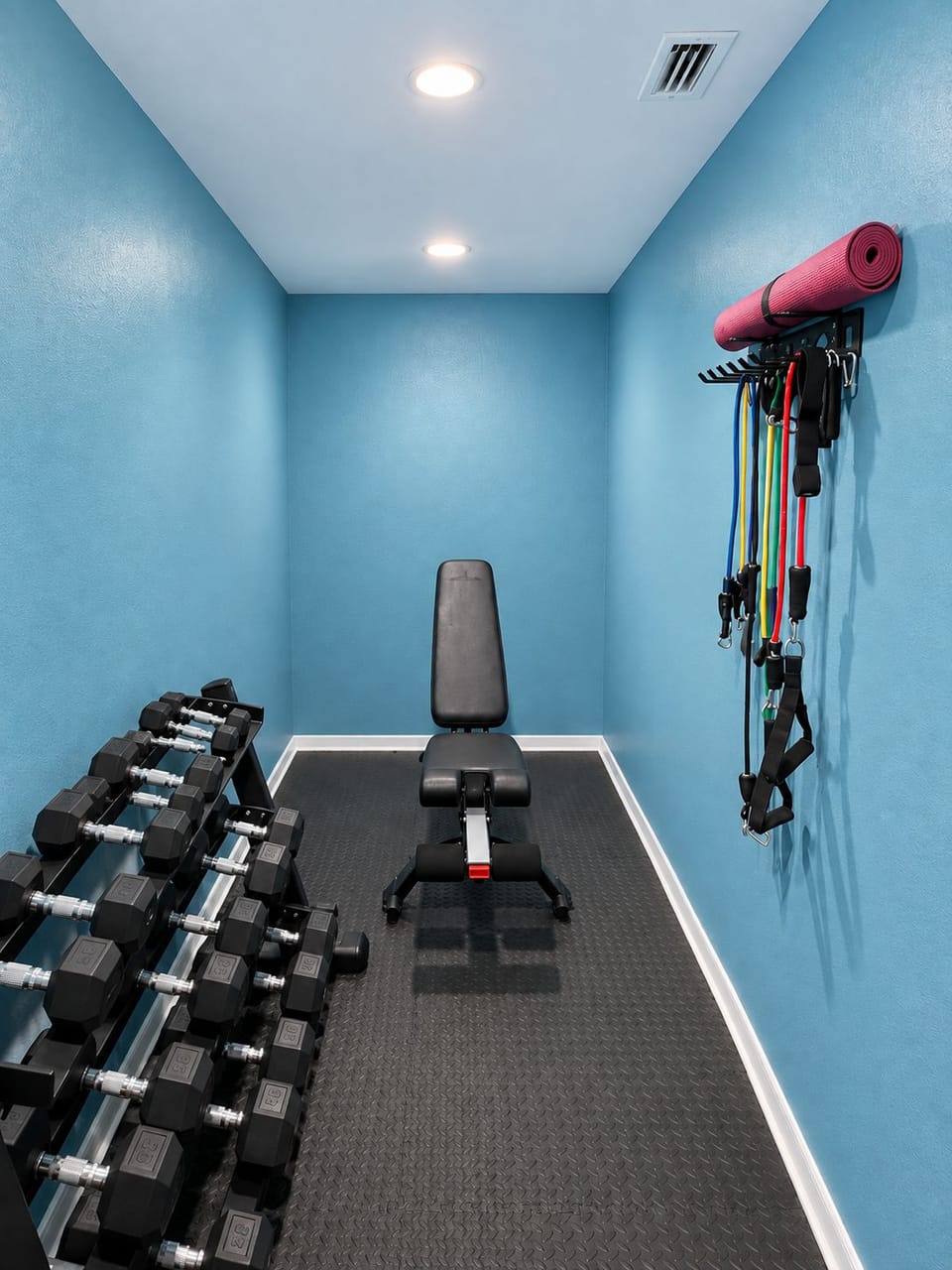 Home gym with weights, resistance bands and yoga mats.