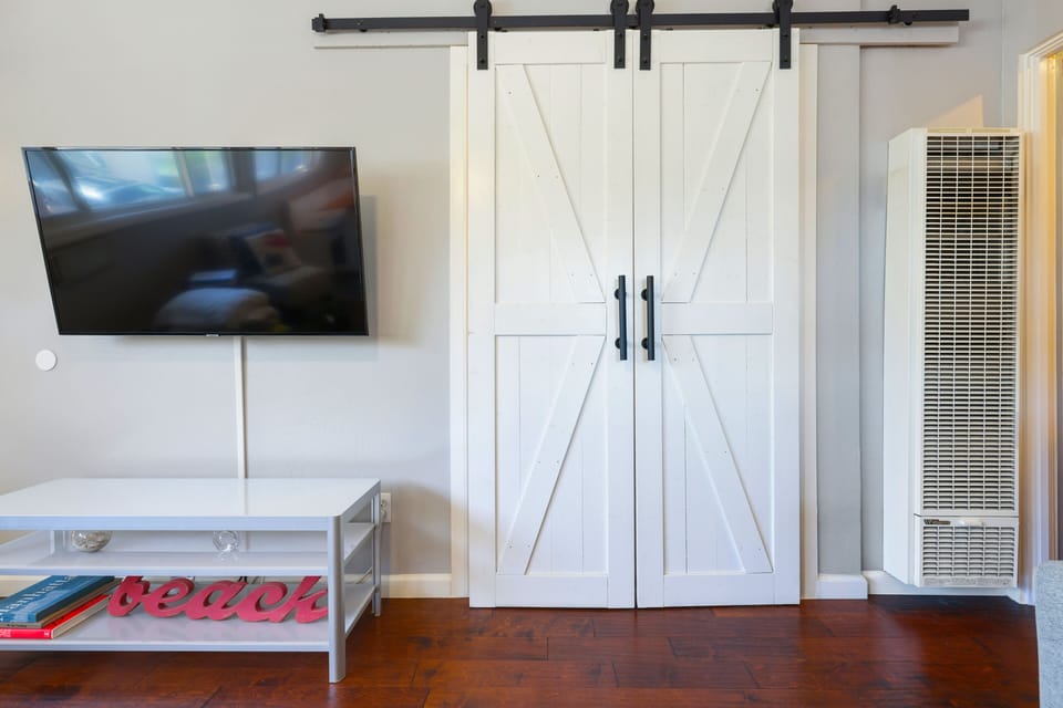 Barn Door that houses all in one washer/dryer, beach chairs, etc. in living room