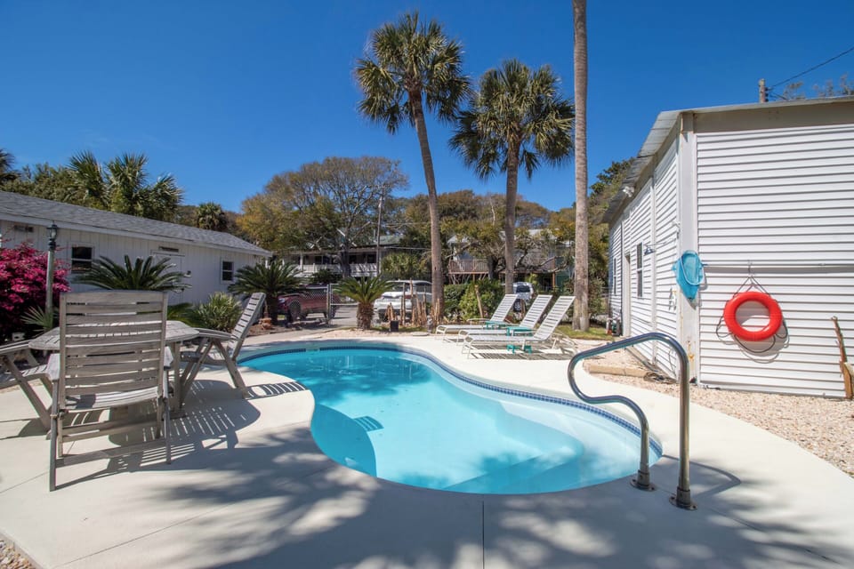 Dive into your own private oasis where crystal-clear waters await beneath swaying palms and endless blue skies.