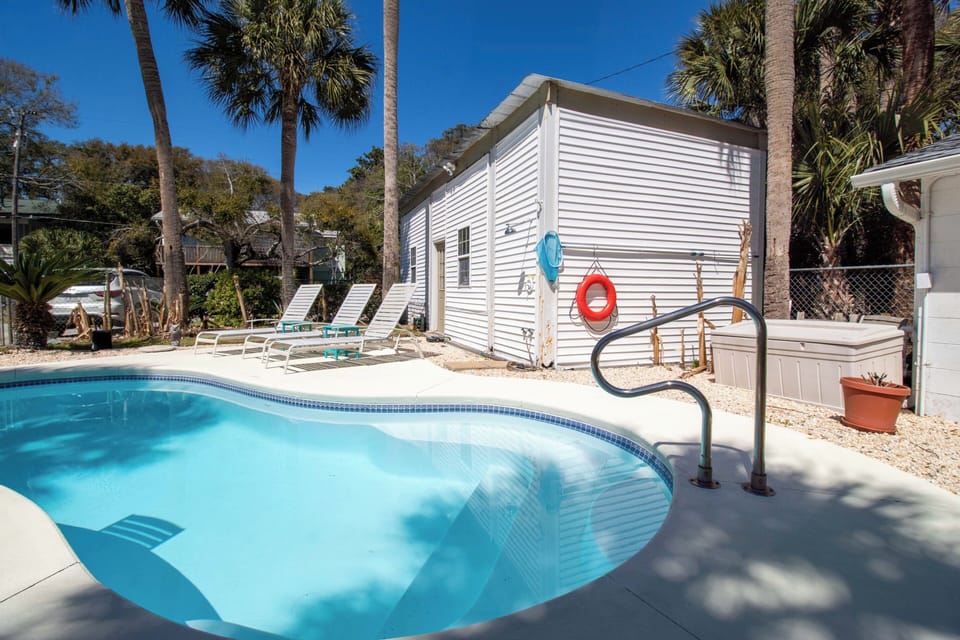 Your private tropical pool awaits surrounded by swaying palms and Florida sunshine for perfect relaxation.