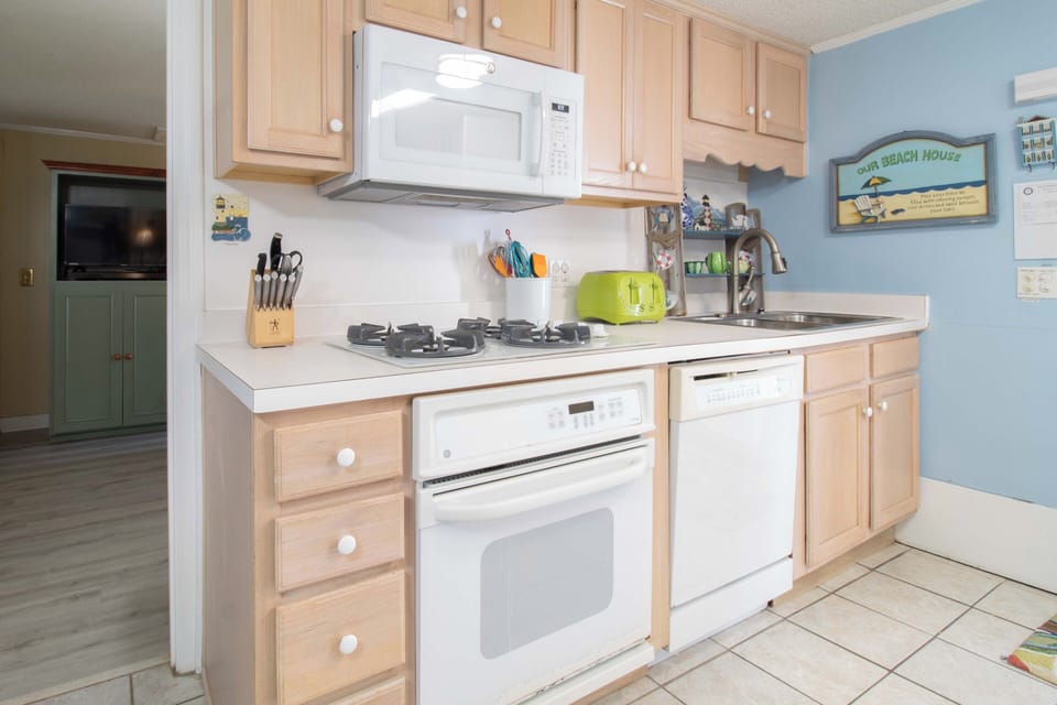 Your bright, fully-equipped kitchen awaits with modern appliances and cheerful coastal décor to make meal prep a breeze.