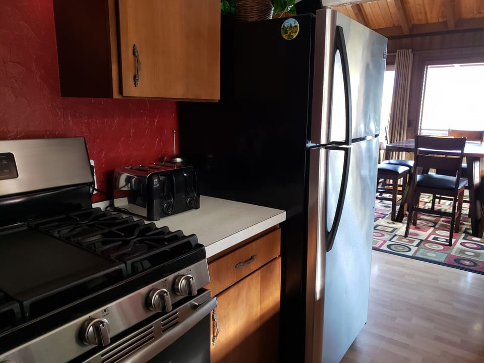 while standing at the gas stove, diningroom and lake view to your right
