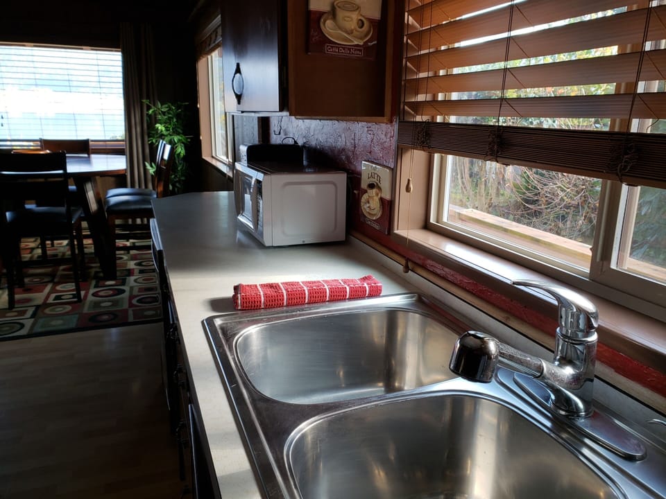While standing at the kitchen sink, view of diningroom and lake view to the left