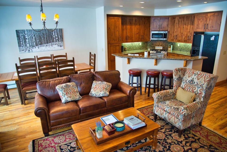 Living room, Dining room with 8 chairs, and kitchen with bar.