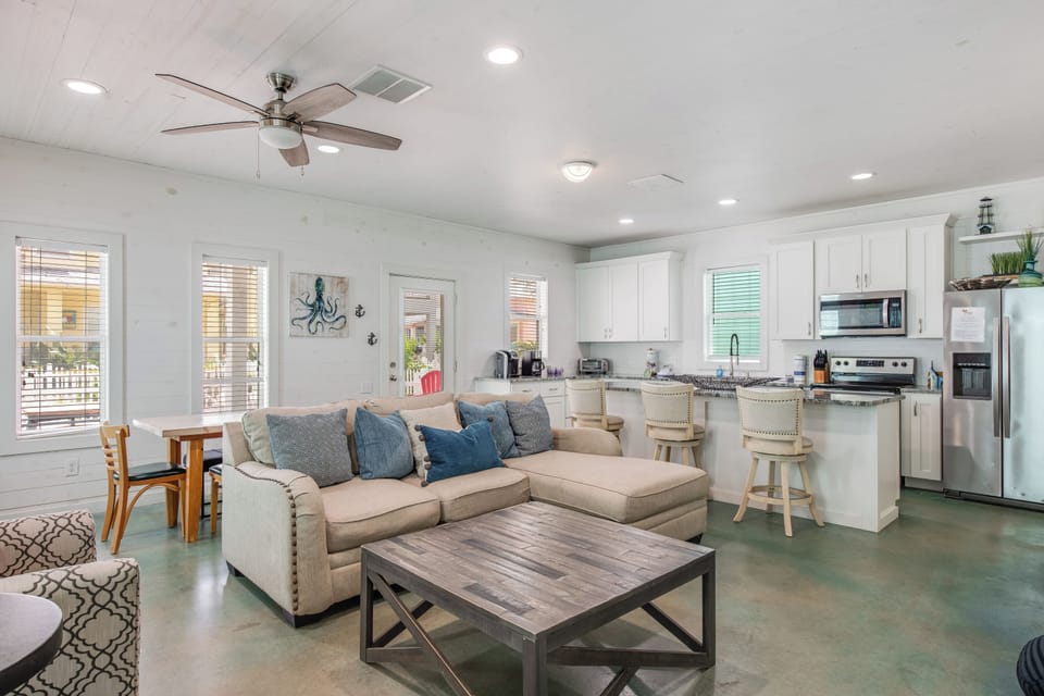 Relax in this bright open-concept living space where your kitchen flows seamlessly into a cozy lounge with coastal charm and modern comfort.
