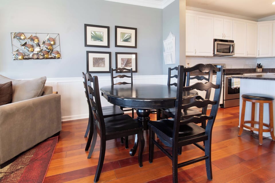 Your elegant dining space flows seamlessly into the fully equipped kitchen, creating the perfect setting for memorable meals together.