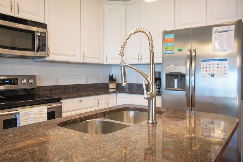 Your fully equipped kitchen features granite counters, stainless appliances, and a professional-style faucet for effortless meal prep.