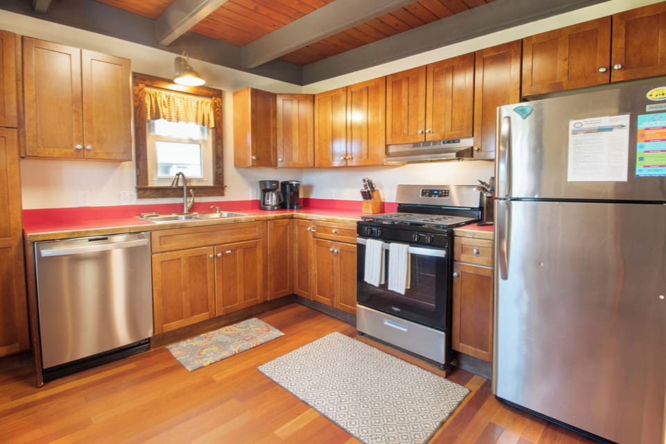 Your fully-equipped kitchen features warm wood cabinetry, stainless steel appliances, and plenty of counter space to prepare your favorite meals in comfort.