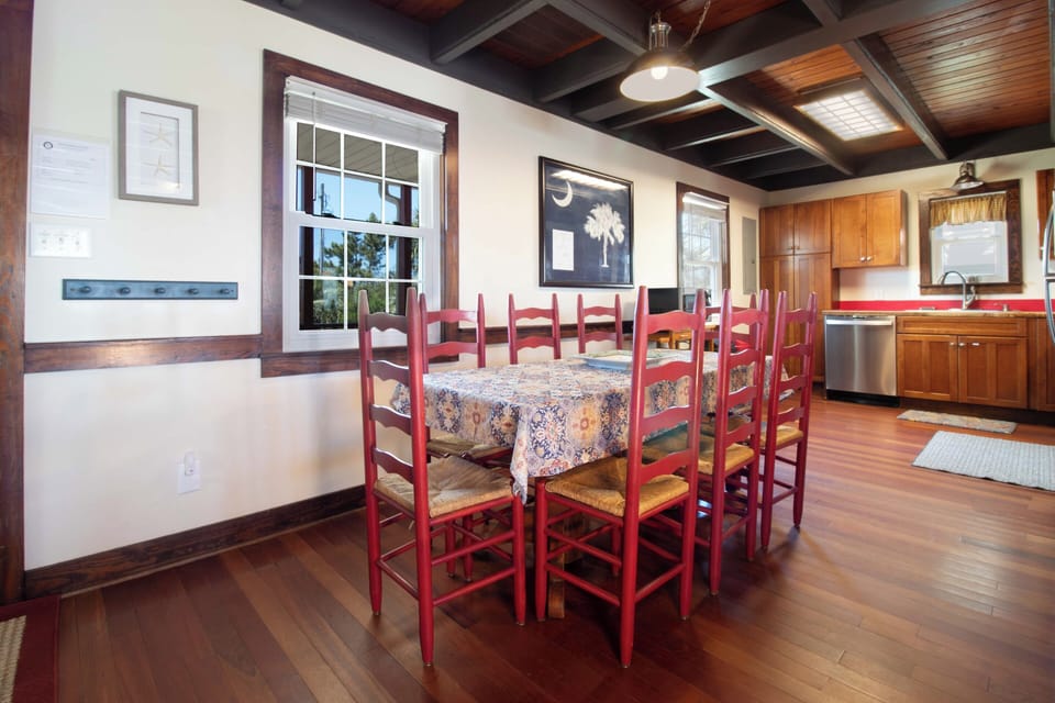 Gather around this spacious dining table with seating for ten, where you'll enjoy meals together under charming exposed beam ceilings. The open kitchen makes meal prep easy and social.