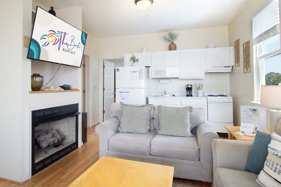 Settle into your bright, open-concept retreat where the kitchen, living area, and cozy fireplace come together seamlessly, inviting you to unwind in coastal comfort.