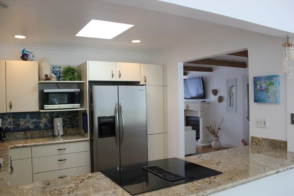 Kitchen, new granite counters and range. Showing open access to living room