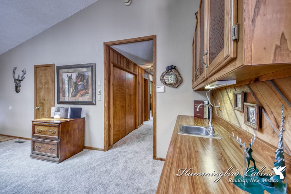 Small bar area off of living room and leading down into the hallway.