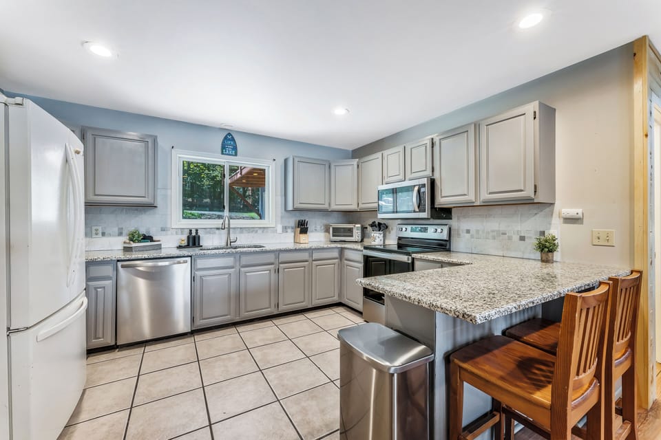 Modern kitchen with pots, pans and dinnerware for family meals.
