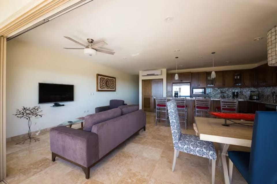 Looking into the open living, dining & kitchen area from the patio. 