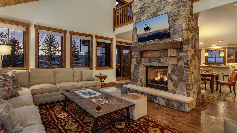 Open great room with cozy couches and fireplace