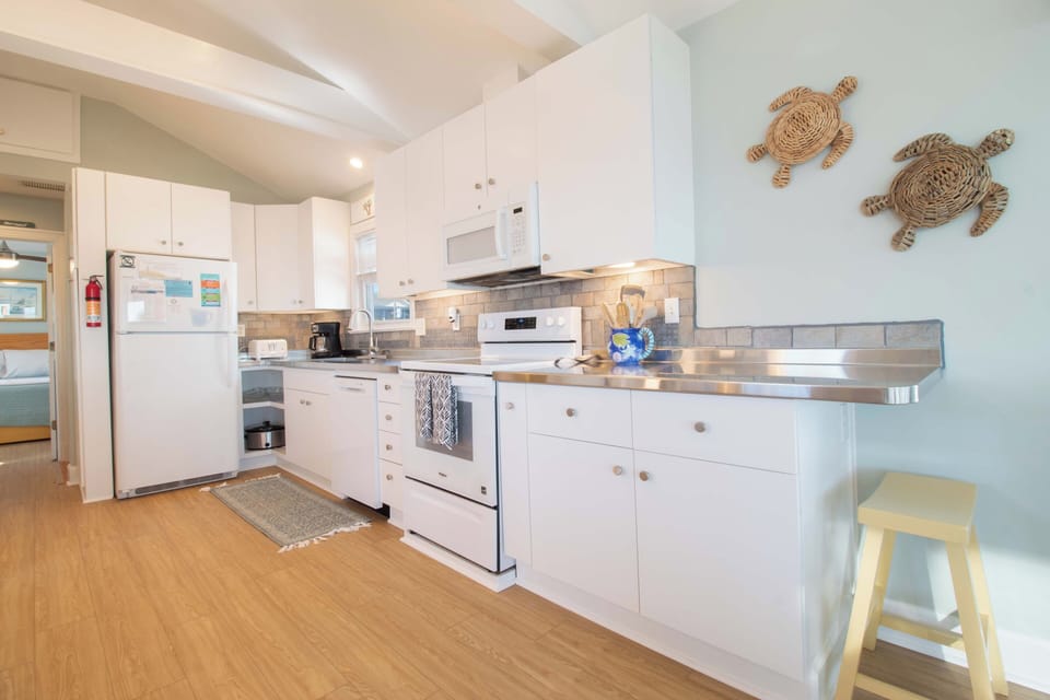 Cook your favorite meals in this bright, fully-equipped kitchen with stainless steel appliances and charming coastal turtle decor.