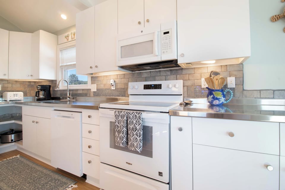 Your bright, fully-equipped kitchen awaits with modern appliances and plenty of counter space for cooking memorable vacation meals together.