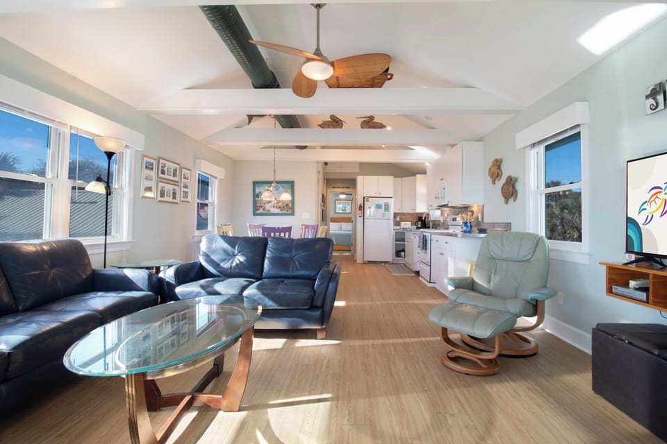 Relax in your bright, modern living space with comfortable leather seating and panoramic windows that flood the room with natural light.