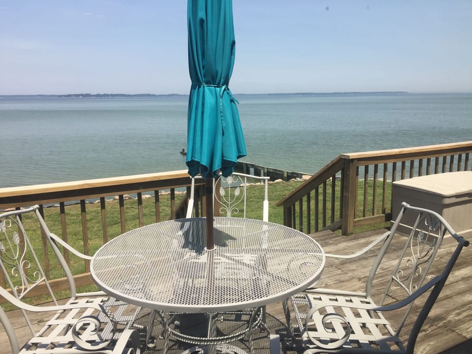 Deck table and chairs with water beyond