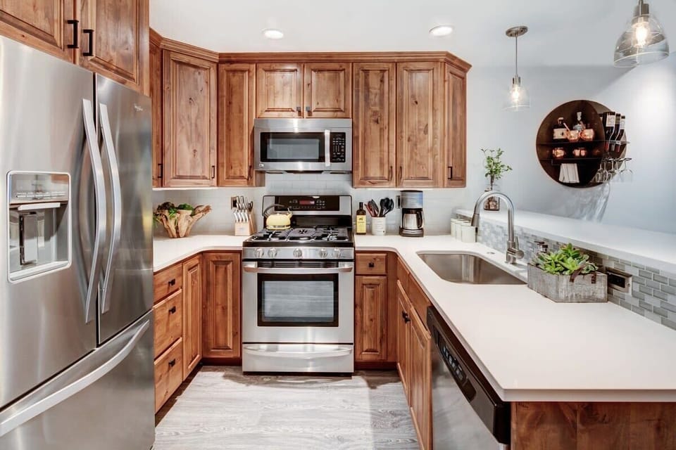 Stylish Kitchen: Whip up meals in this modern kitchen featuring elegant wood cabinetry and sleek appliances!
