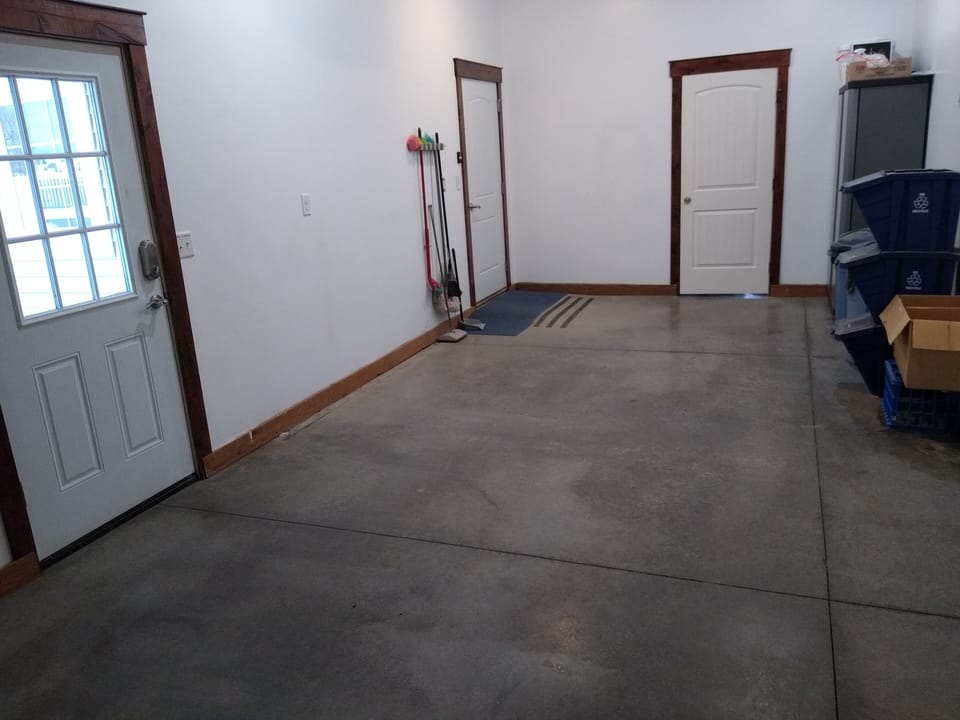 Attached garage - door to outside on left, door to laundry room in center. 