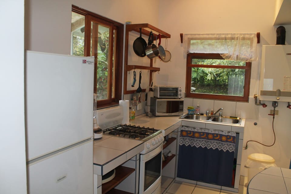 Full kitchen with microwave, toaster oven, coffee maker and double sink.