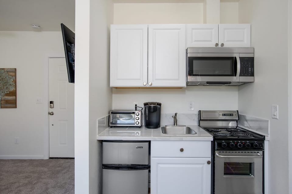 Kitchen.  TV and front entrance seen on left