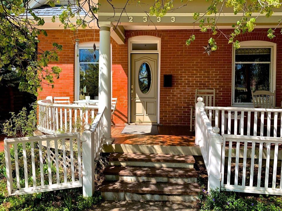 Sunny front porch with dining for 2 and 2 rocking chairs 