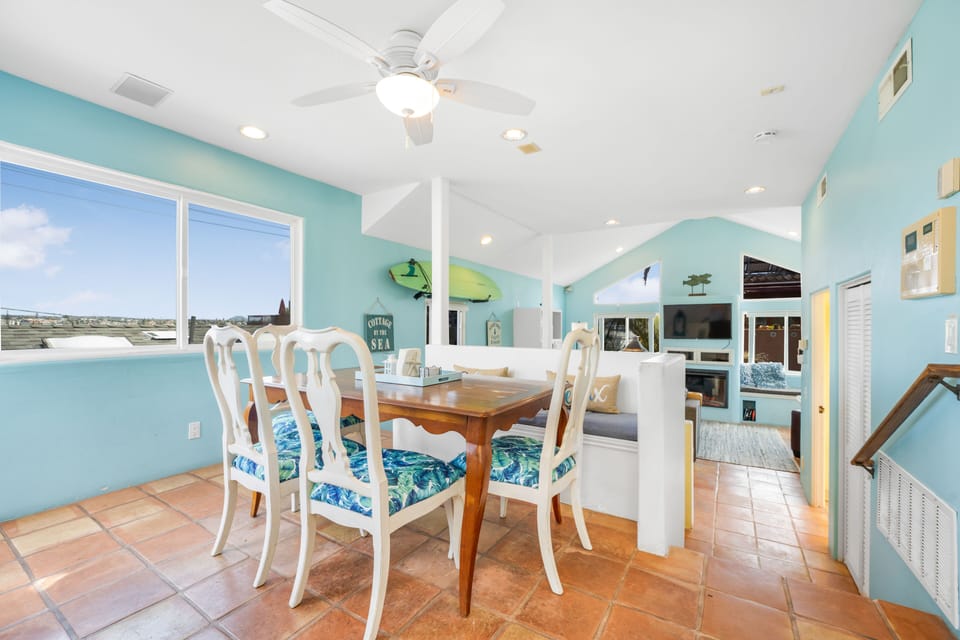 The bright, sunny dining area off of the kitchen seats 6. (2 extra chairs avail)