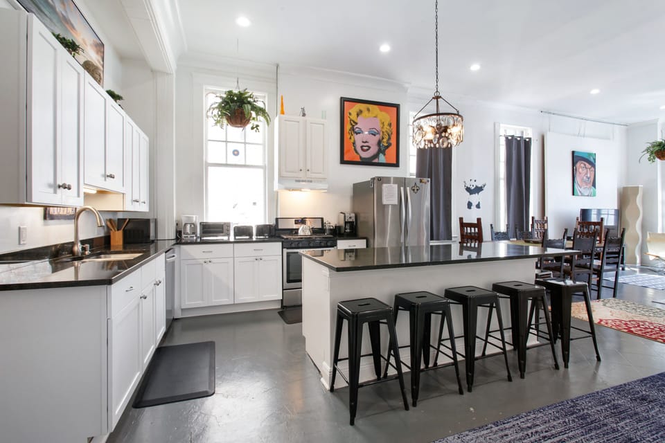 Bright, spacious kitchen with 6-seat island is open to dining and  living areas.