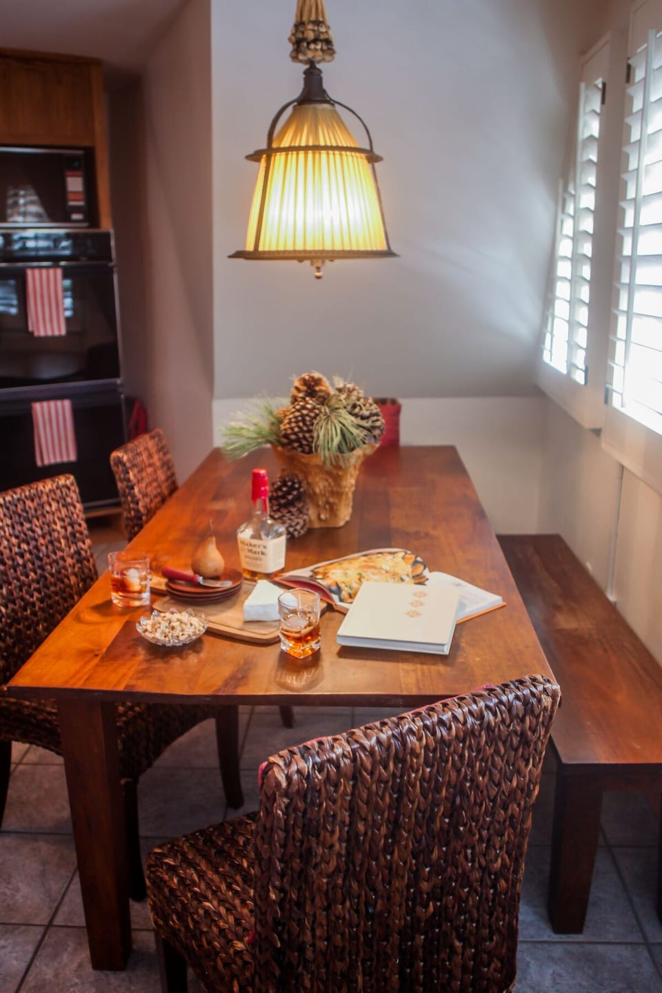 Dining table has seating for 8, with chairs and a bench seat.