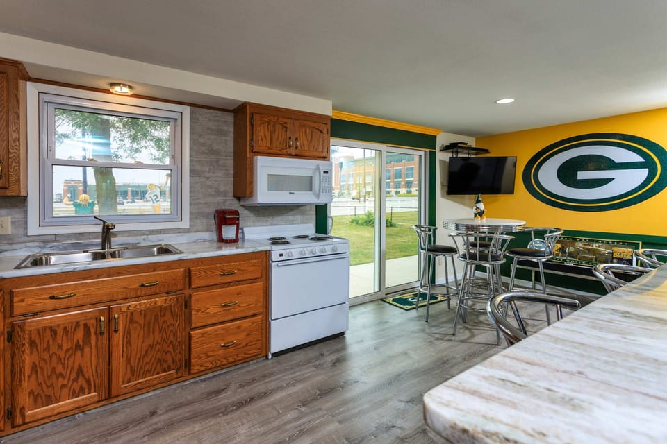 Kitchen with entrance to patio and view of Lambeau