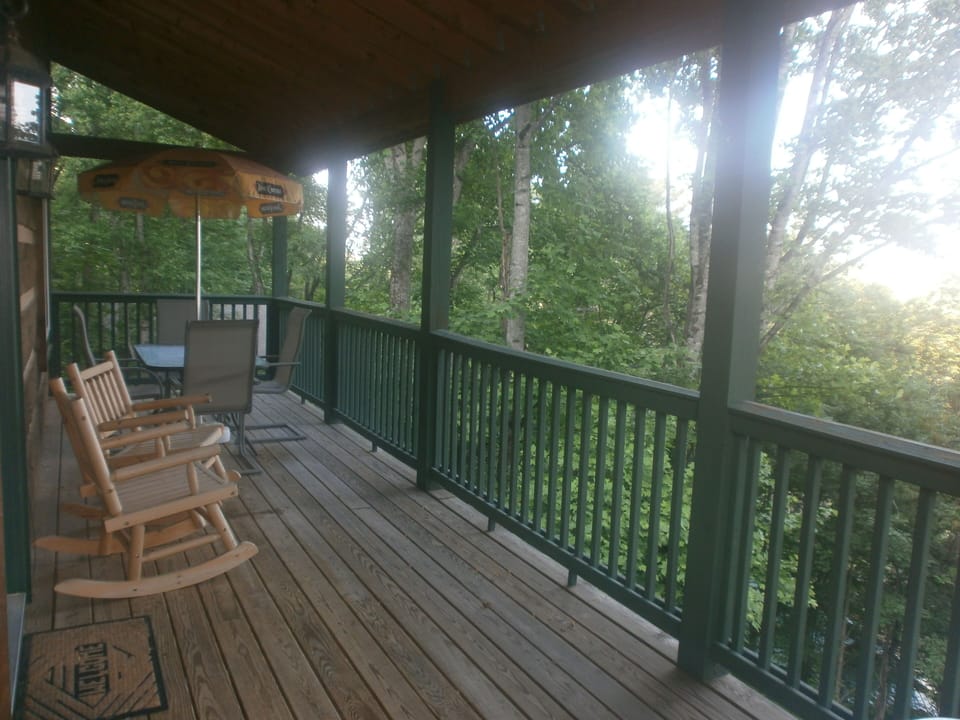 Main level deck with seating for four & a stainless steel gas grill not pictured