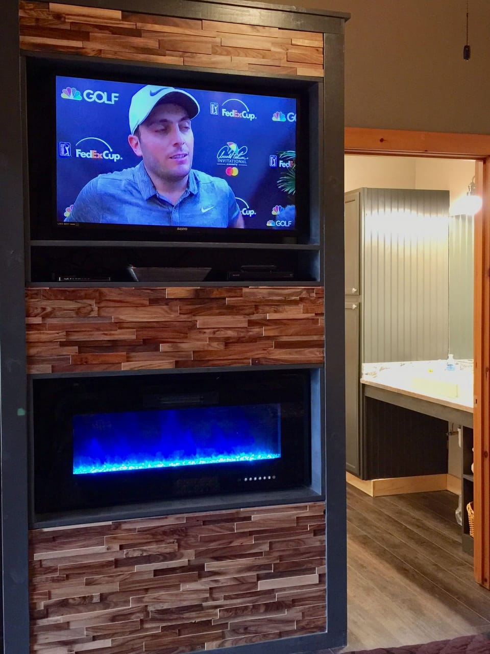 43" TV and electric LED ribbon fireplace on the opposite side of bedroom
