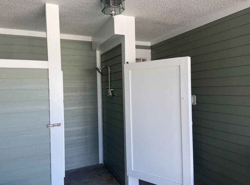 Outdoor shower along with a Weber grill on this ground level. 