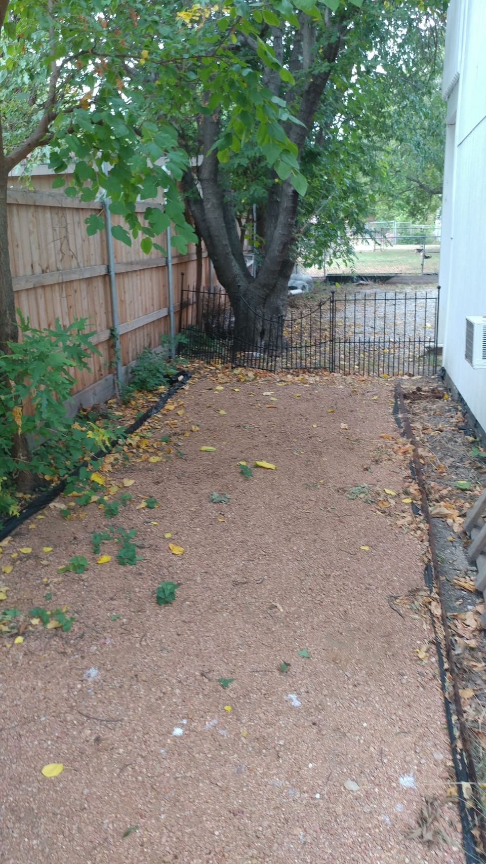 fenced in play area of crushed pink granite for kids and pets