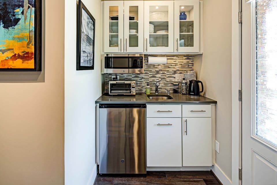 Kitchen with micro, fridge, toaster over, hot plate & hot pot for french press.