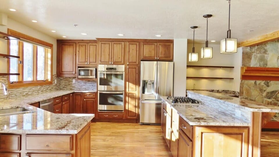 Gourmet open kitchen, granite countertops and fully-equipped, and breakfast bar seating