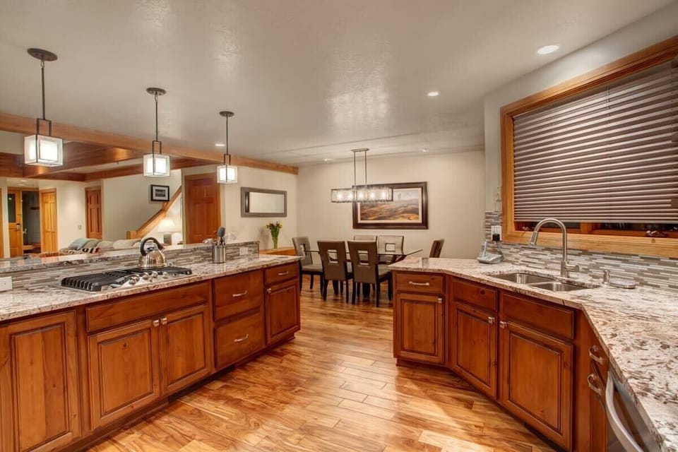 Gourmet open kitchen, granite countertops and fully-equipped, and breakfast bar seating