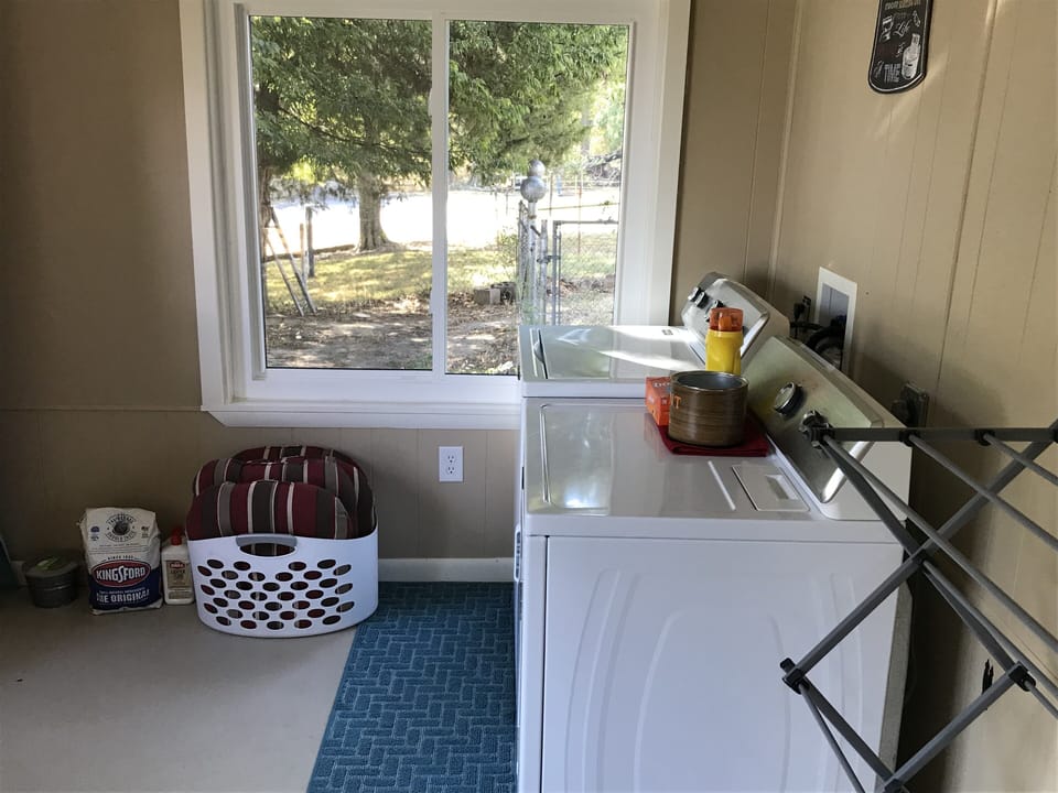 A full sized washer and dryer in the large laundry room.