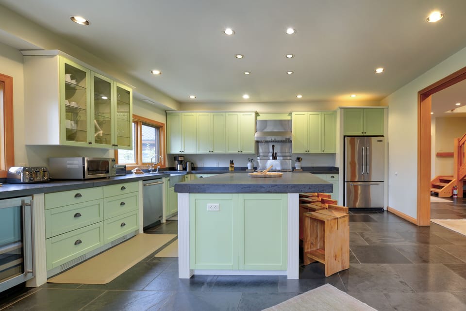 the large fully equipped gourmet kitchen w/ huge island, and high end appliances